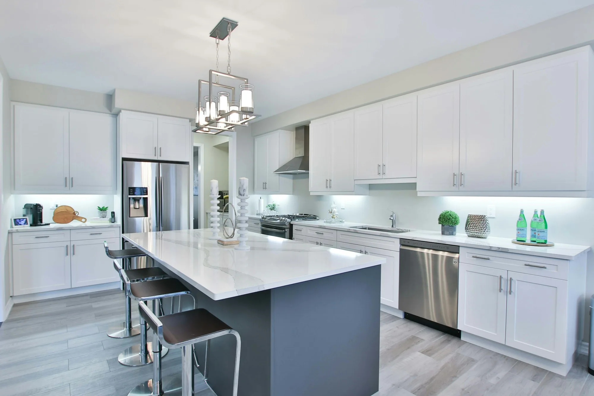 White shaker-style kitchen cabinets with brushed nickel hardware — stock photo, not a Proper Paint project