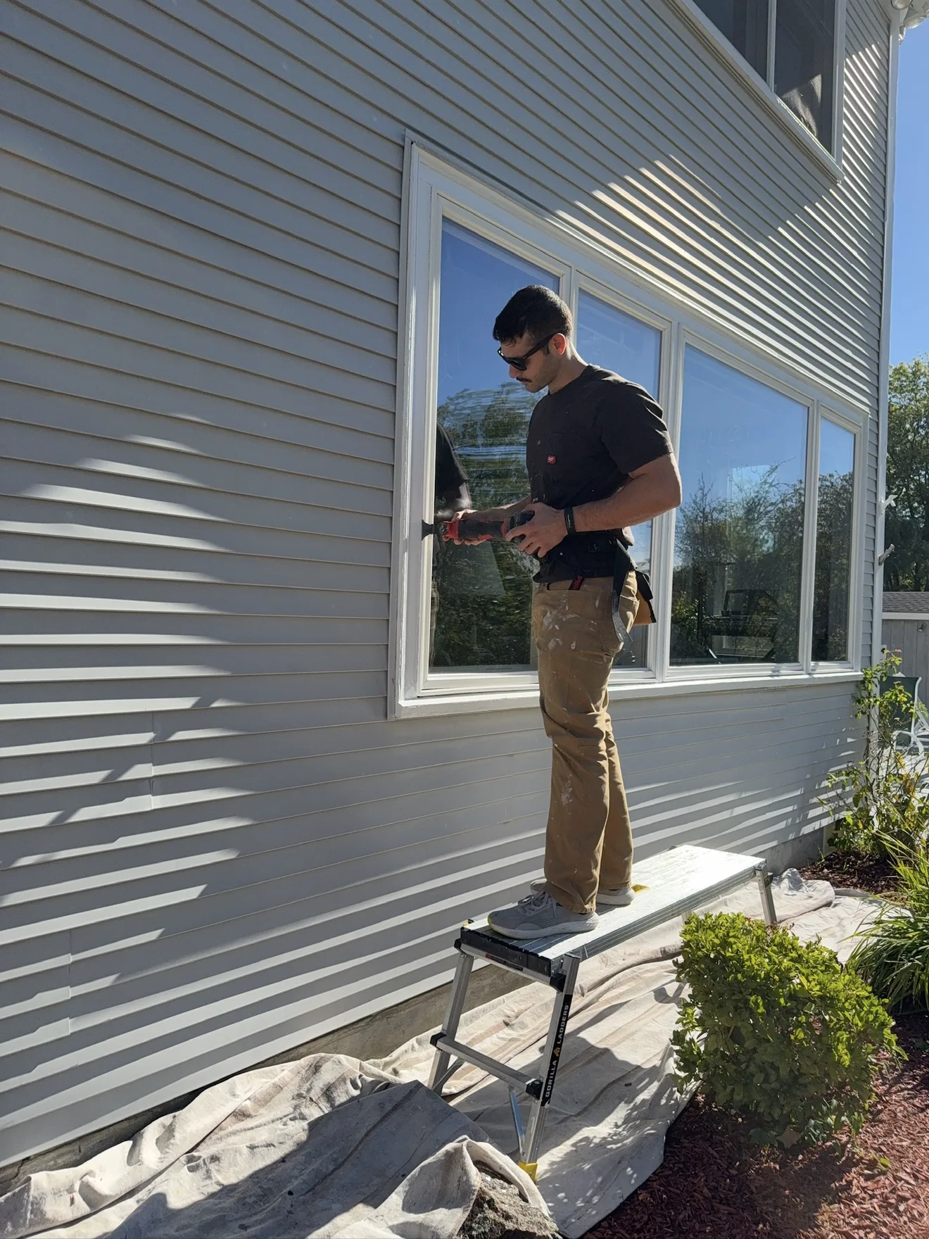 Proper Paint crew member sealing a window before the final coat