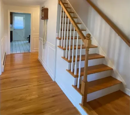 After: the same stairway and hallway repainted in a soft, light neutral