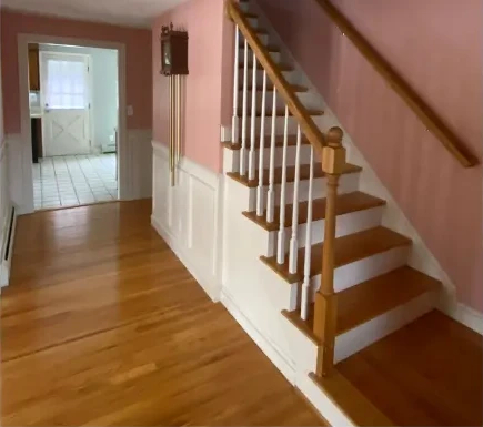 Before: a Proper Paint stairway and hallway with a bold pink wall color
