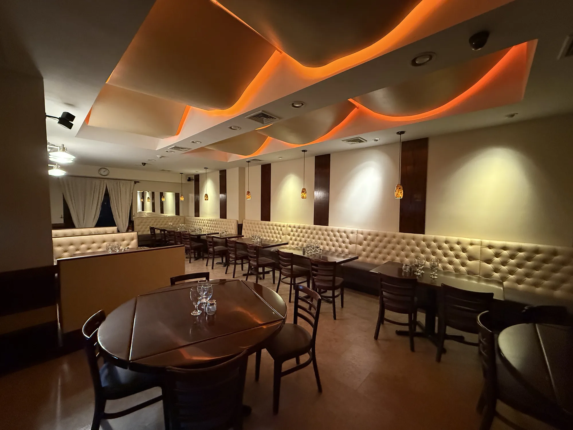 Completed commercial dining room with warm lighting and finished ceiling detail