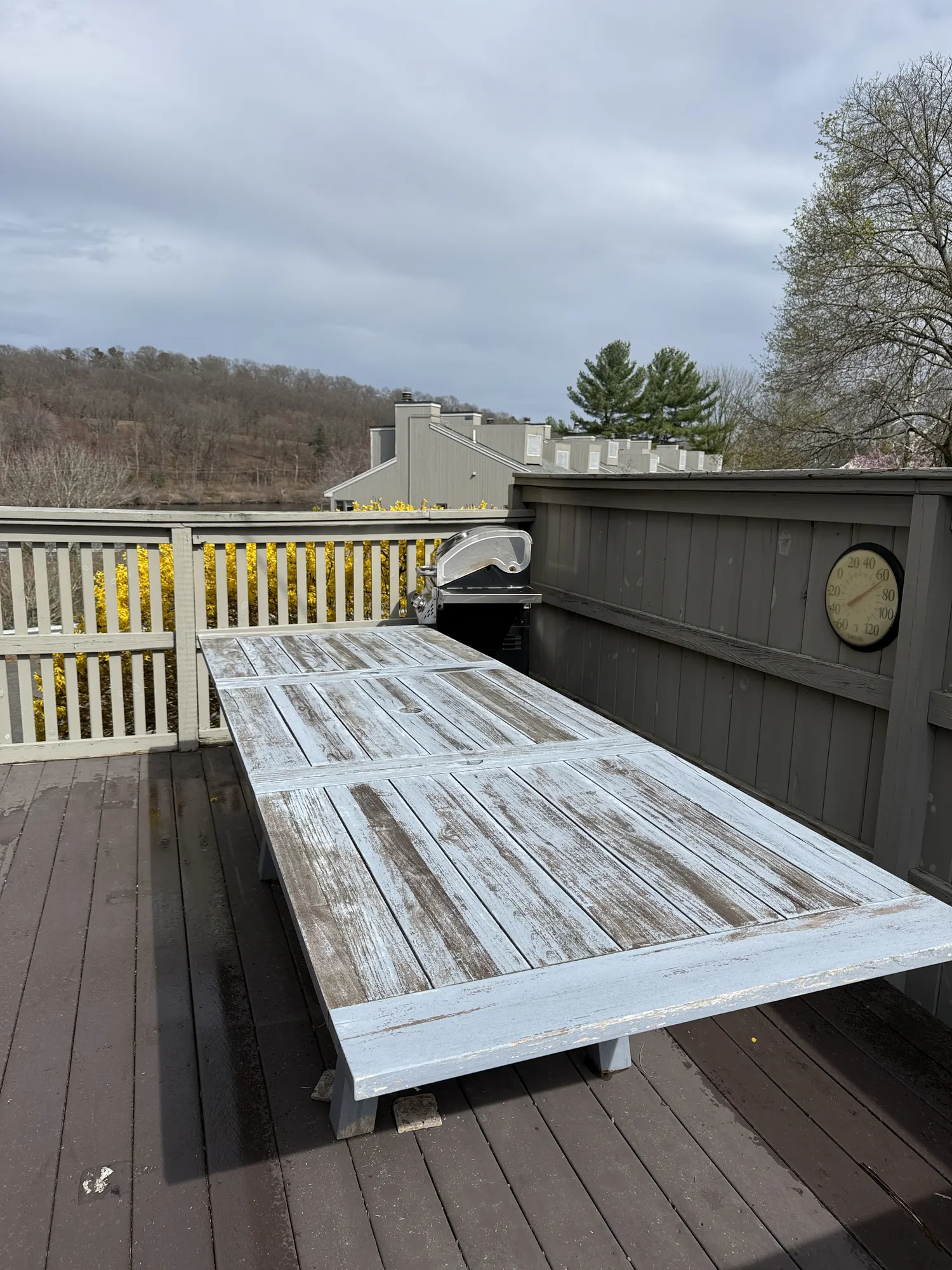 Before: an outdoor dining table with a worn, patchy gray finish