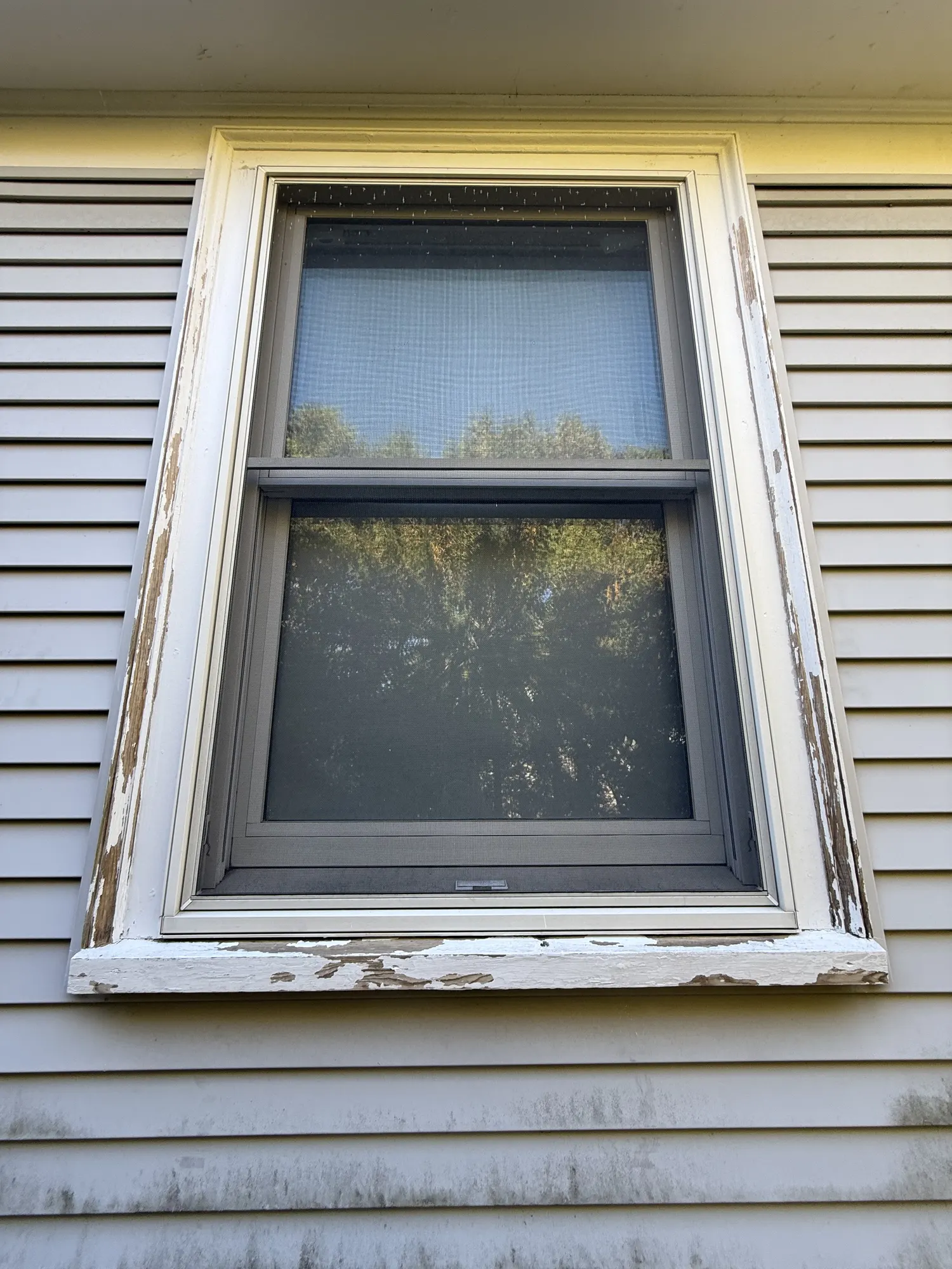 Before: a window frame with cracked, peeling paint down to bare wood